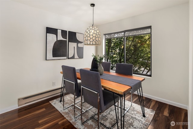 dining space featuring a baseboard heating unit and dark wood-type flooring