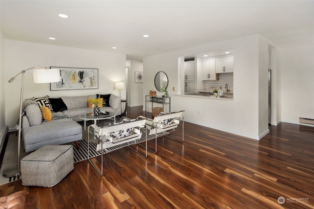 living room featuring recessed lighting, baseboards, and wood finished floors