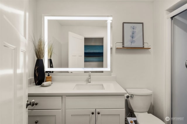 bathroom with toilet and vanity