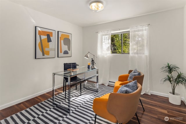 home office with a baseboard heating unit, baseboards, and wood finished floors