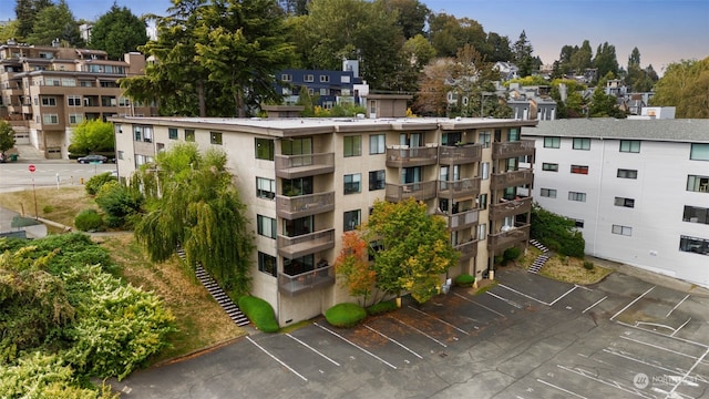 view of building exterior featuring uncovered parking