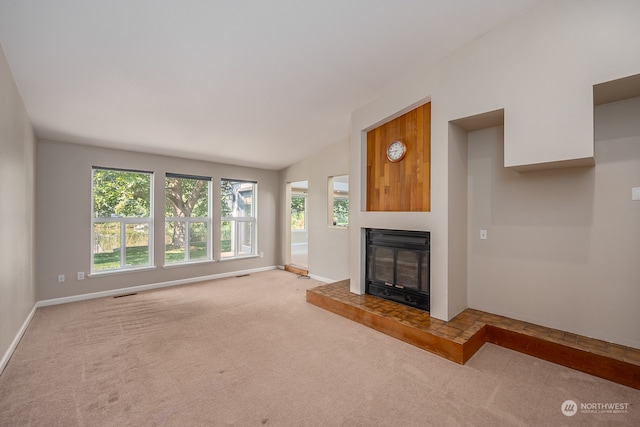 unfurnished living room featuring lofted ceiling and light colored carpet