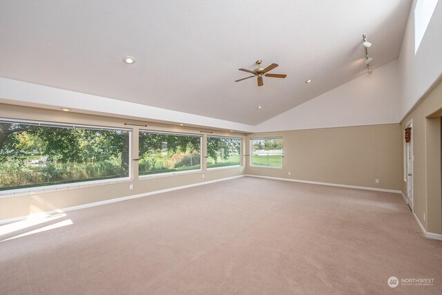 carpeted spare room with high vaulted ceiling and ceiling fan