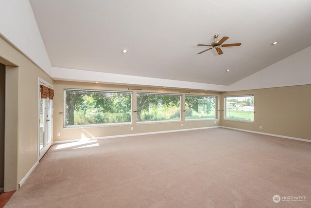 carpeted spare room with lofted ceiling and ceiling fan