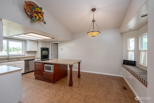 kitchen featuring hanging light fixtures, white cabinetry, sink, black appliances, and a kitchen breakfast bar