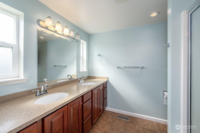 bathroom featuring tile patterned flooring and vanity