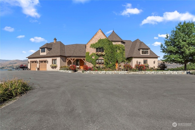 view of front of house with a mountain view and a garage