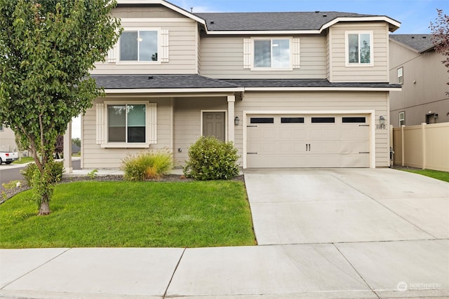 view of front facade with a garage and a front lawn