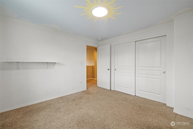 unfurnished bedroom featuring carpet floors and a closet