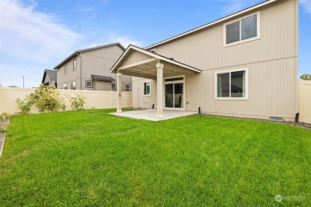 rear view of house featuring a patio and a lawn