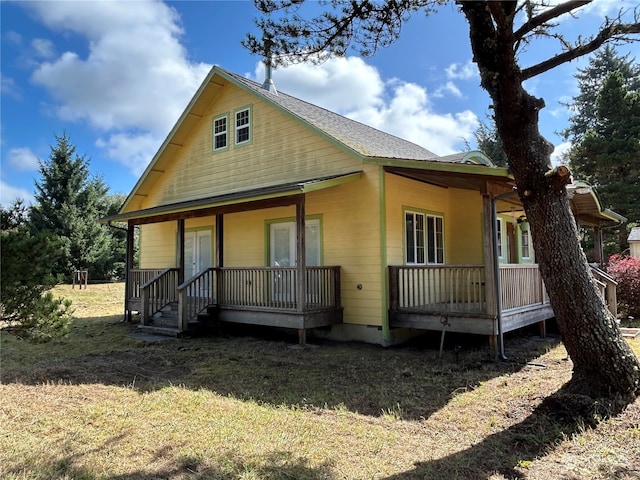 rear view of property with a porch