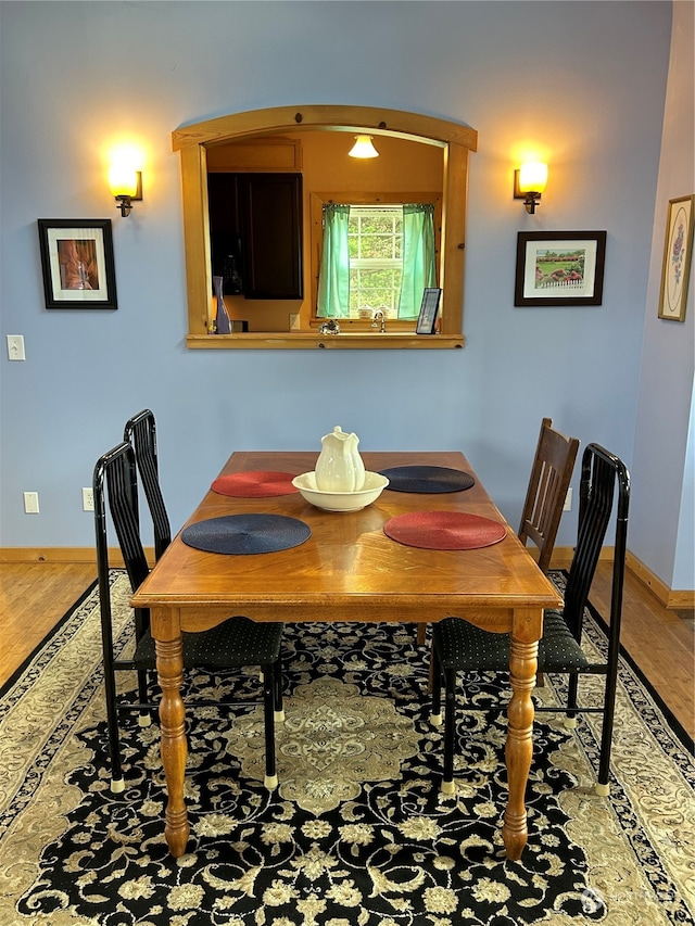 dining room with hardwood / wood-style flooring