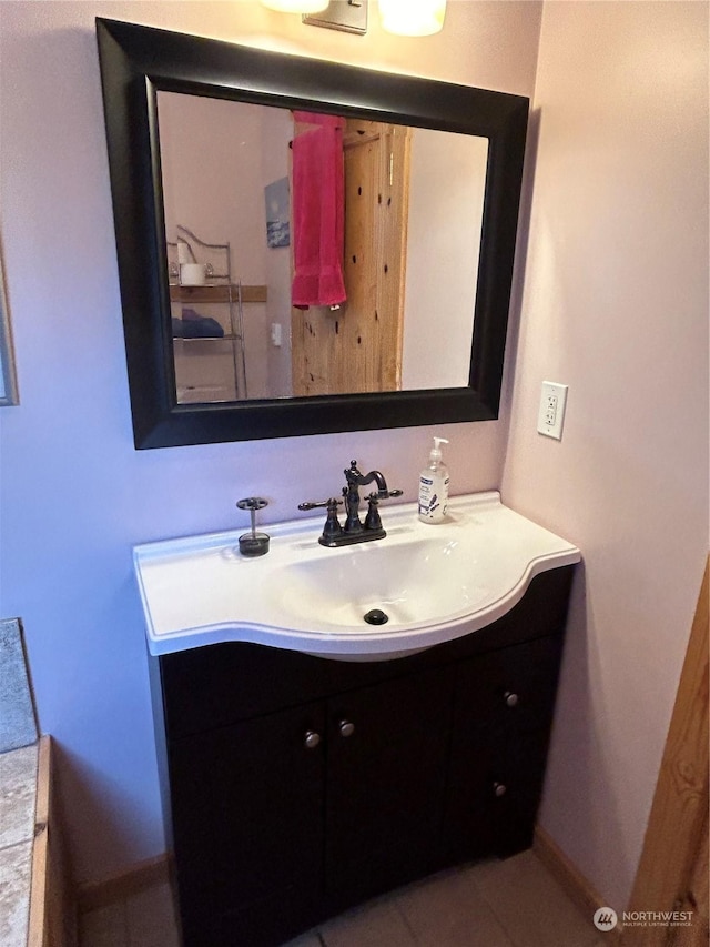 2407 Oysterville Rd, Oysterville, WA 98641 - bathroom with tile patterned floors, baseboards, and vanity