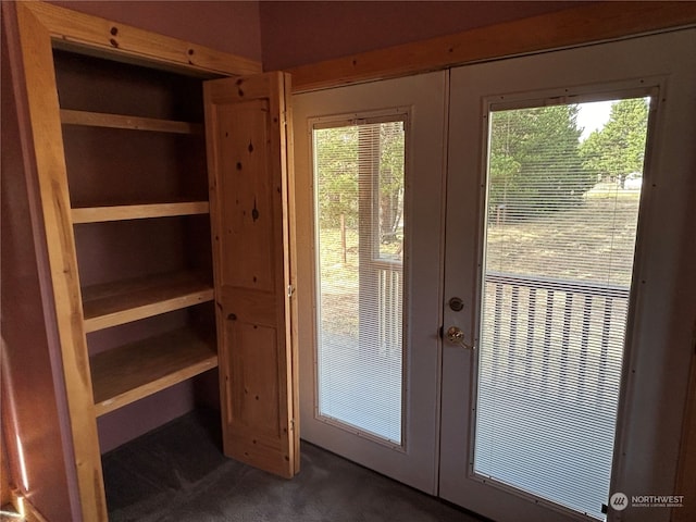 entryway with french doors and dark carpet