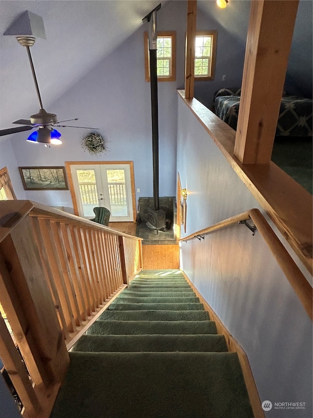 stairs with hardwood / wood-style floors, french doors, ceiling fan, and lofted ceiling