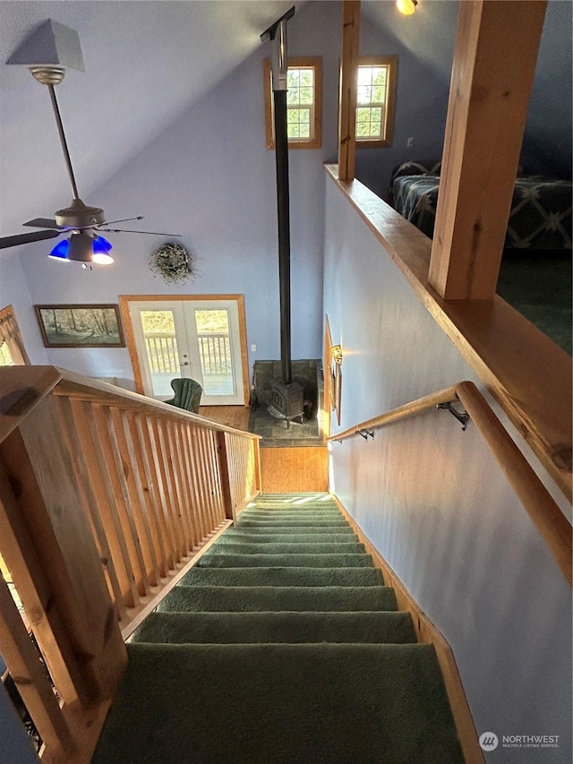 2407 Oysterville Rd, Oysterville, WA 98641 - stairway with a wood stove, a ceiling fan, and vaulted ceiling