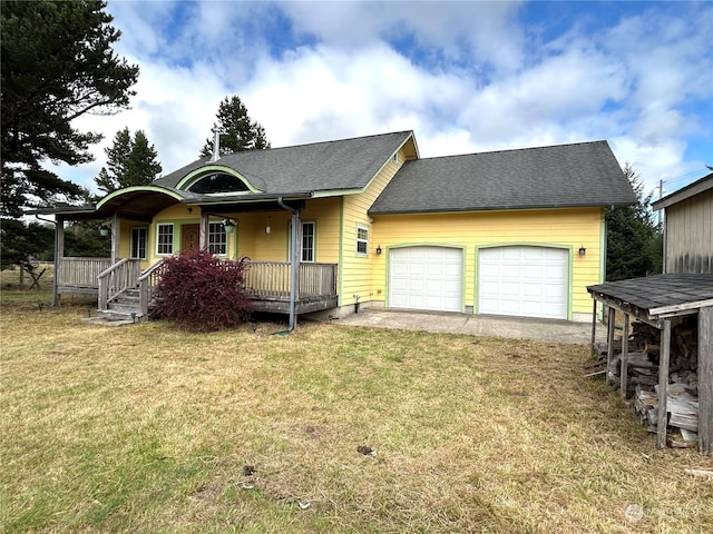 view of front of house featuring a porch, a garage, and a front lawn