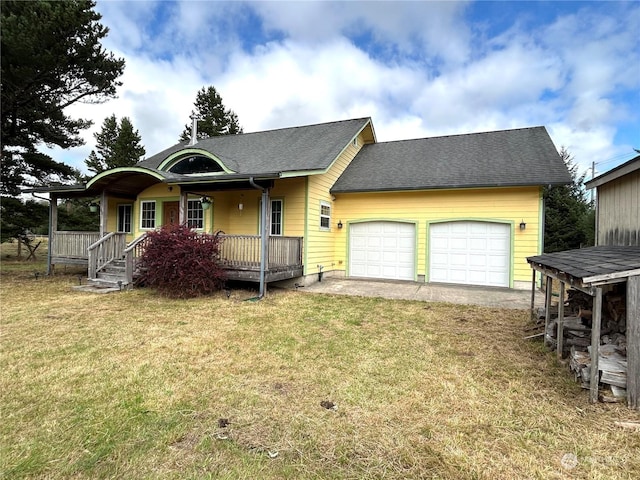 2407 Oysterville Rd, Oysterville, WA 98641 - view of front of house with a garage, a shingled roof, a front lawn, and covered porch