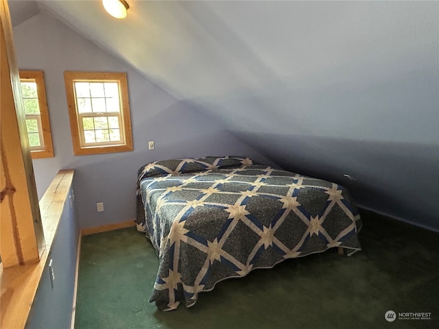 carpeted bedroom with vaulted ceiling