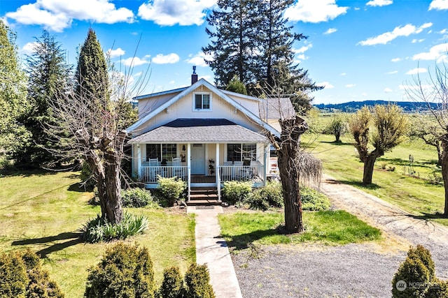 view of front facade with covered porch and a front yard