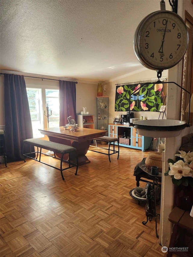 dining area with parquet floors and a textured ceiling