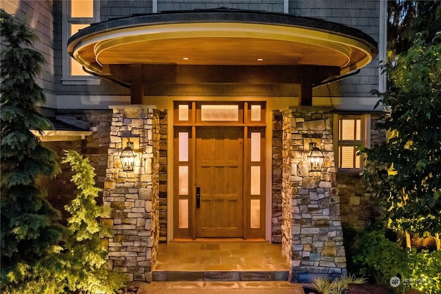 property entrance with stone siding