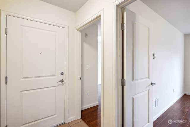 corridor featuring hardwood / wood-style floors