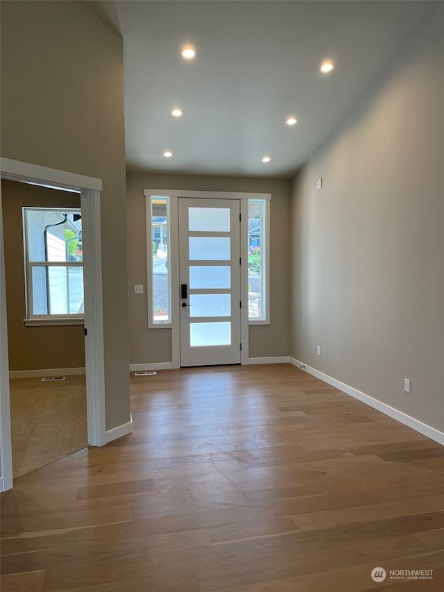 foyer entrance featuring light hardwood / wood-style floors and plenty of natural light