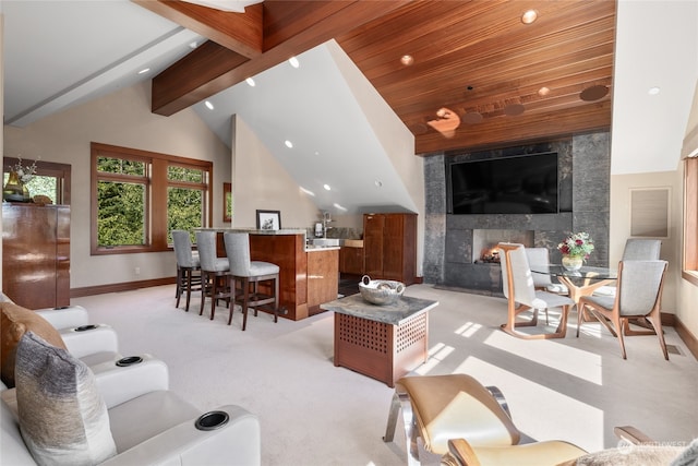 carpeted living room featuring a high end fireplace and high vaulted ceiling