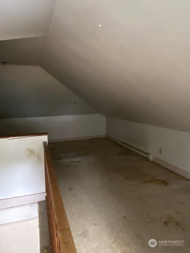 bonus room with baseboard heating and lofted ceiling