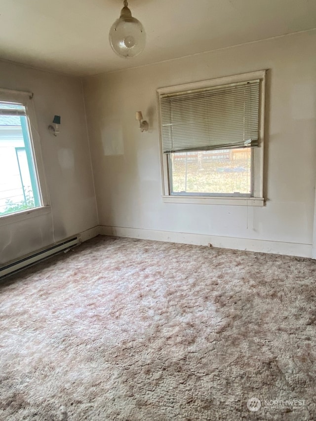 unfurnished room with a baseboard heating unit