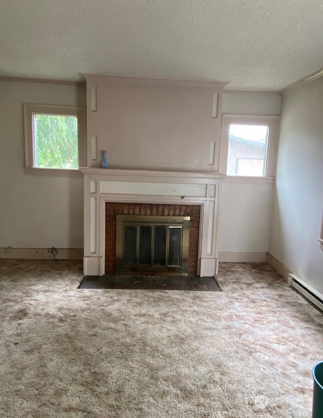 unfurnished living room with carpet floors, crown molding, baseboard heating, and a textured ceiling