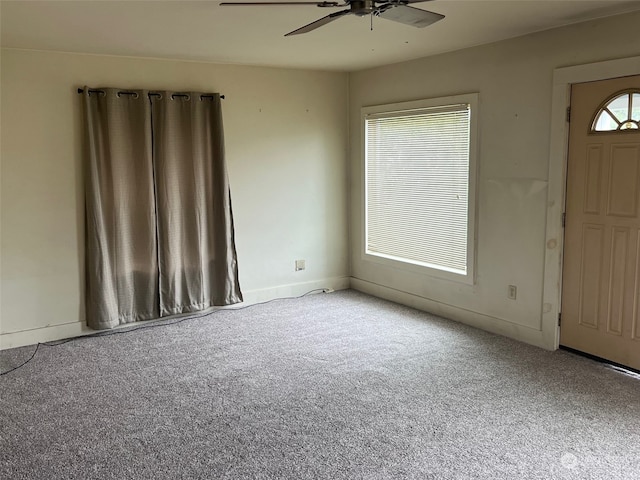 empty room with ceiling fan and carpet