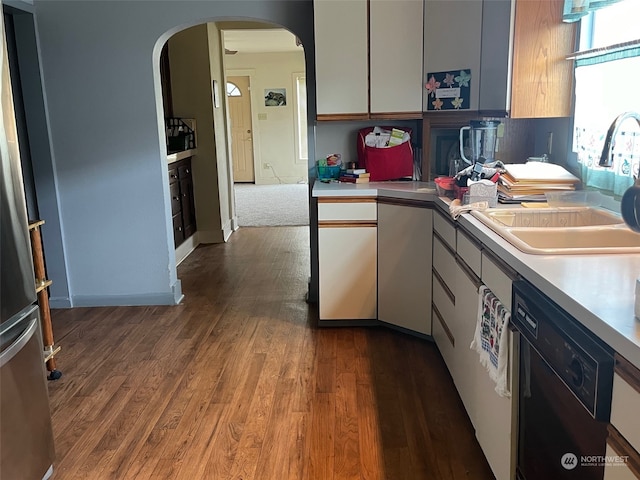 kitchen featuring dishwasher, sink, and hardwood / wood-style floors