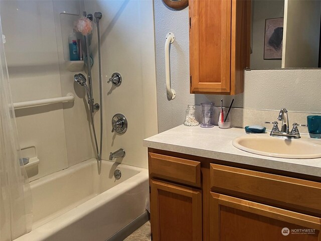 bathroom featuring  shower combination and vanity