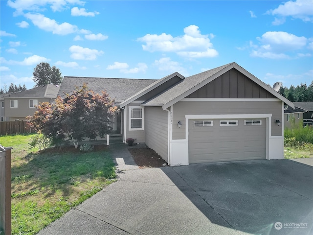 view of front of property with a front yard and a garage