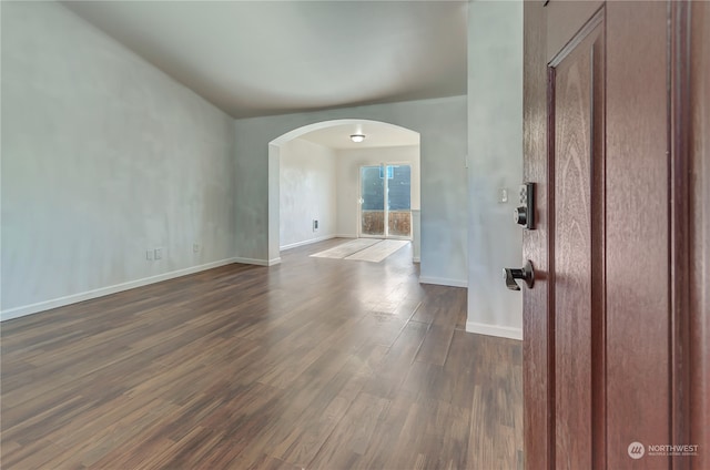 empty room with dark hardwood / wood-style floors