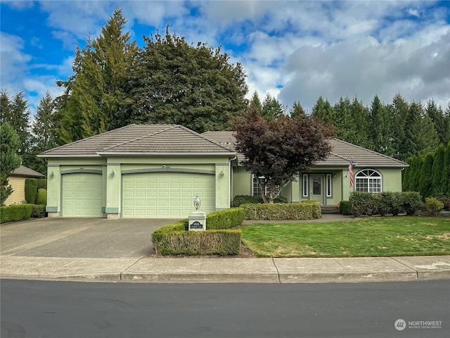 view of front of property featuring a front lawn and a garage