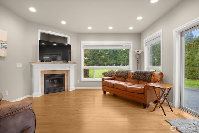 living room featuring recessed lighting, plenty of natural light, and light wood-style floors