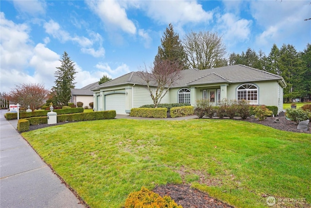 ranch-style home featuring a garage, a front yard, and a tiled roof