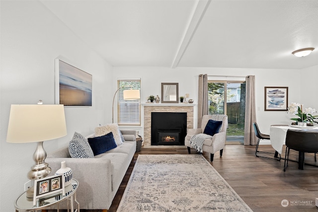 living room with dark hardwood / wood-style flooring and beamed ceiling