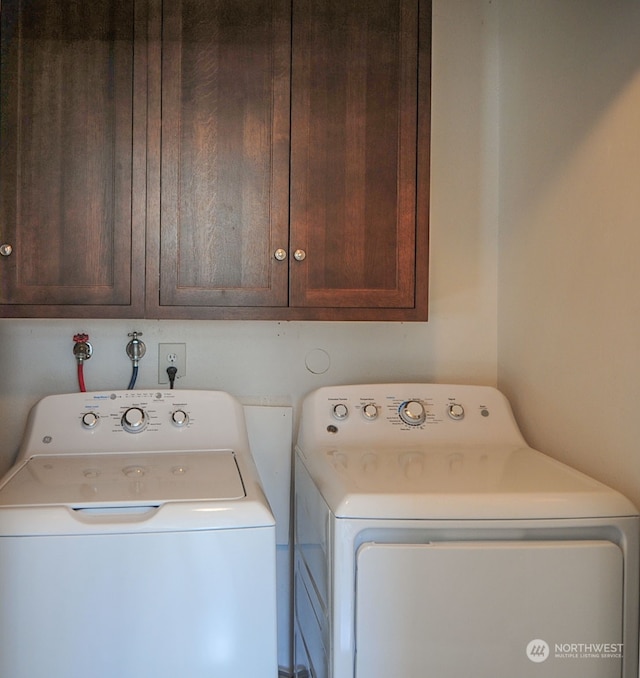 laundry area with cabinets and washer and clothes dryer