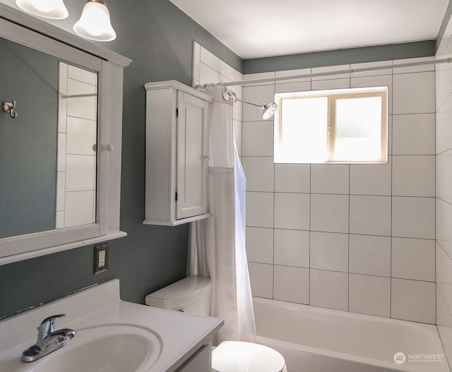 full bathroom with shower / bath combo with shower curtain, toilet, and vanity