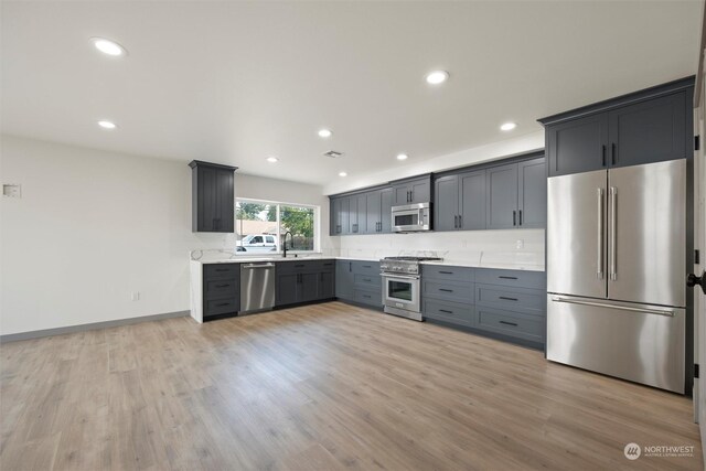 kitchen featuring light hardwood / wood-style flooring, sink, gray cabinets, and appliances with stainless steel finishes