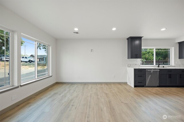 kitchen with dishwasher, light hardwood / wood-style floors, and sink