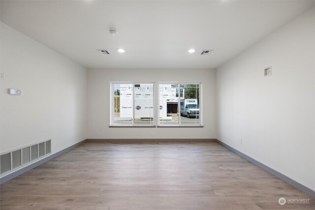 empty room with light hardwood / wood-style floors