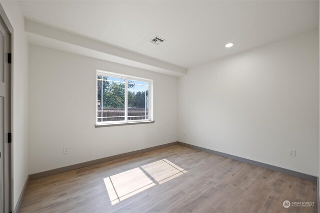 spare room featuring light hardwood / wood-style floors