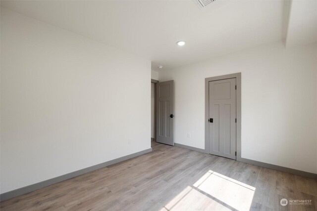 unfurnished room with light wood-type flooring