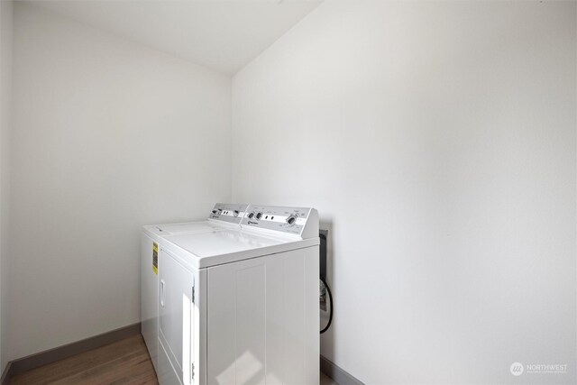 laundry room featuring dark hardwood / wood-style floors and separate washer and dryer