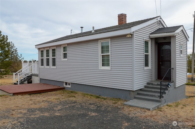 view of property exterior featuring a wooden deck